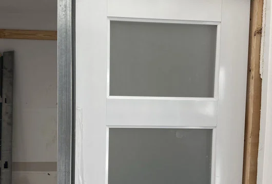 Completed white sliding pocket-door detail