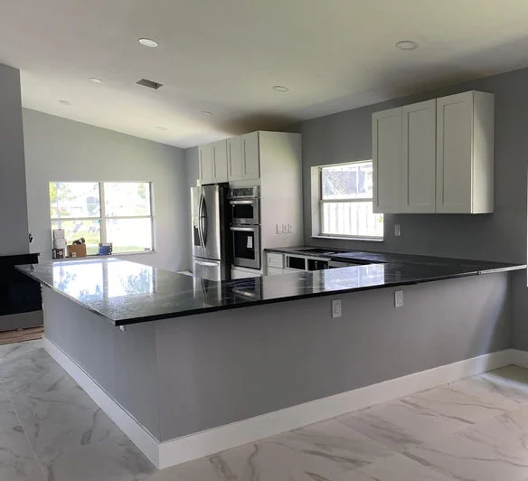 Finished kitchen with a large dark island and modern cabinets