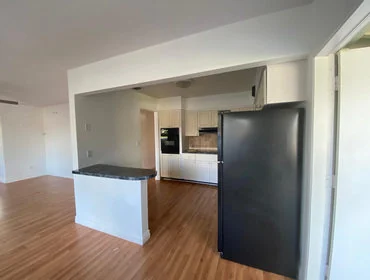 Kitchen before renovation, with darker finishes and a more dated layout