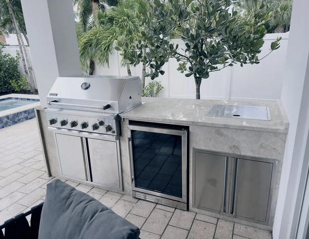 Completed outdoor barbecue station with stone countertop and stainless appliances